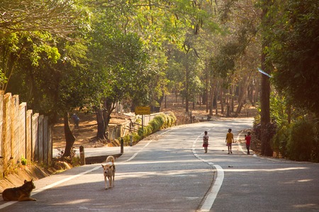Children walk to go home on a winding road in the morning.Kanchanaburi, Thailandのeditorial素材
