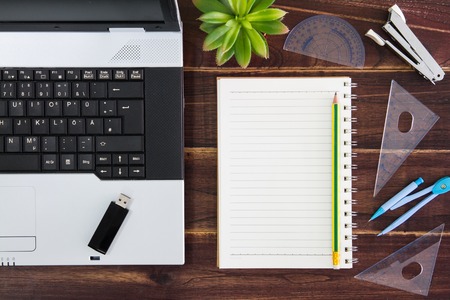 Notebook computer on the desk.USB flash drive stick,paperの写真素材