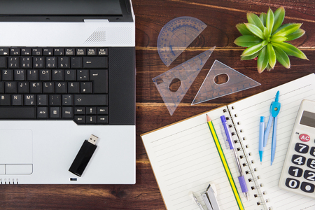 Notebook computer on the desk.USB flash drive stick,paperの写真素材
