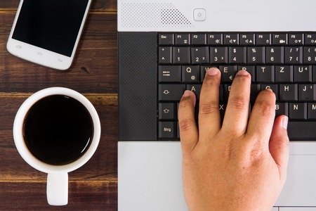 Notebook computer on the desk,coffee cup,smartphoneの写真素材