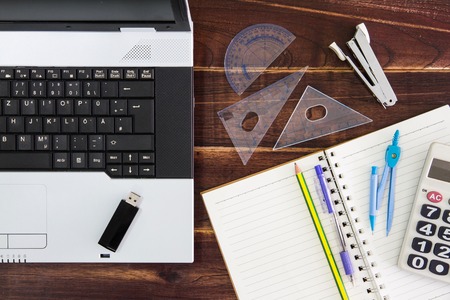 Notebook computer on the desk.USB flash drive stick,paperの写真素材