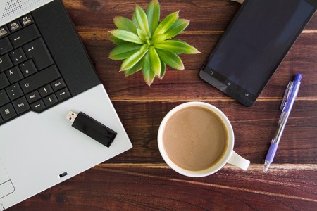 Notebook computer on the desk,USB flash drive stick,coffee cupの写真素材