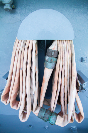 The old fire hose in the reel.の写真素材