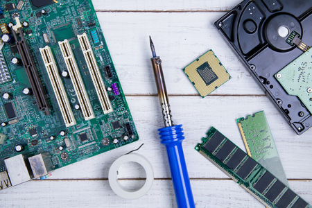 Computer motherboard, Computer Parts, Hard disk, Ram and equipment repair on the white wooden background.の写真素材