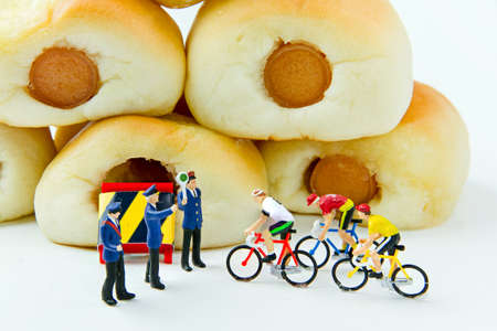 Tiny toys and Sausage bread.Concept food background.の写真素材