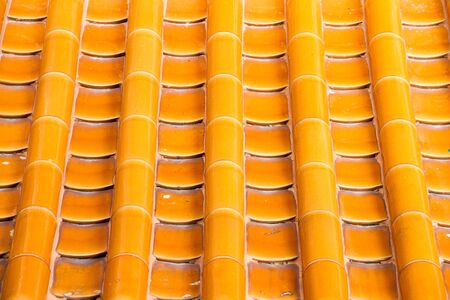 Yellow orange glazed terracotta  roof tiles of a Chinese temple.