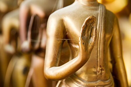 Hands of buddha statue in temple Thailand.selective focus.の写真素材