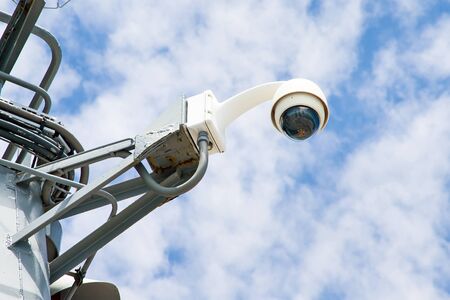 360 degrees surveillance camera on blue sky background closeup.Security camera .