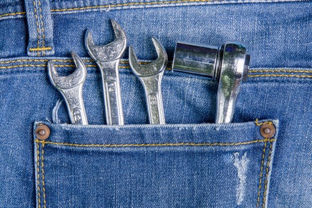 Wrench tool in the back pocket jeans.Jeans background