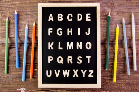 Wooden english alphabet A-Z on the blackboard.Color pencil on wooden tableの写真素材