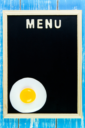 Wooden english alphabet menu and Fried egg on the blackboardの写真素材
