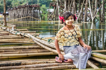 Sagklaburi, Kanchanaburi, Thailand - September, 29, 2013 : Unidentified name beautiful girls Mon nation sitting on a bamboo bridge.のeditorial素材
