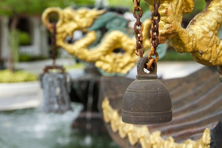 Closeup of a bell hanging in Chinese temple.の写真素材