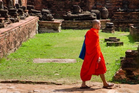 Ayutthaya, Thailand - October, 21, 2016 : Unidentified name buddhist monk walks tourist to visit at Wat Mahathat, Ayutthaya, Thailandのeditorial素材