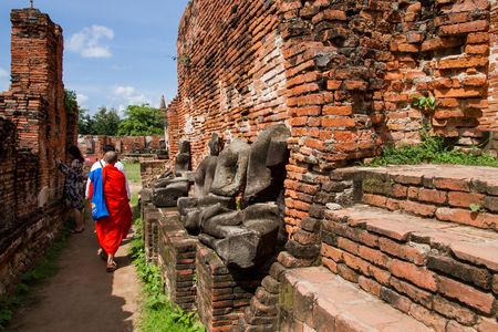 Ayutthaya, Thailand - October, 21, 2016 : Unidentified name buddhist monk walks tourist to visit at Wat Mahathat, Ayutthaya, Thailandのeditorial素材
