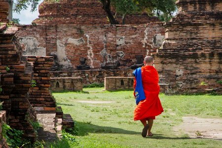 Ayutthaya, Thailand - October, 21, 2016 : Unidentified name buddhist monk walks tourist to visit at Wat Mahathat, Ayutthaya, Thailandのeditorial素材