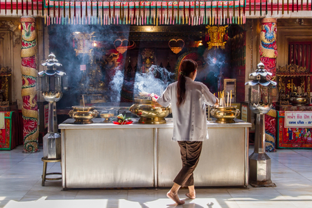 Ayutthaya, Thailand - October, 21, 2016 : Unidentified woman took off from Joss incense burner to leave at Wat panancherng, Jao Mae Soi Dork Mark the Chinese Shrine at Ayuttaya.のeditorial素材