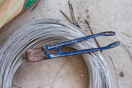 Pliers cutting rebar and thick galvanised aluminium iron metal wire.の写真素材