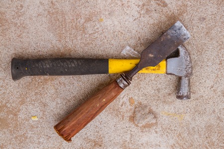 Yellow Hammer and and chisel tool placed on concrete floor.の写真素材