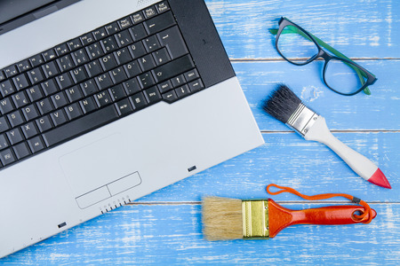Office workplace, laptop computer, glasses and construction hardware tools.Business concept.の写真素材