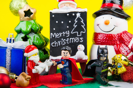 Nonthaburi, Thailand - November, 04, 2016 : Lego Santa Claus giving gifts to Lego super man and batman at Christmas.Theme Christmas day background.のeditorial素材