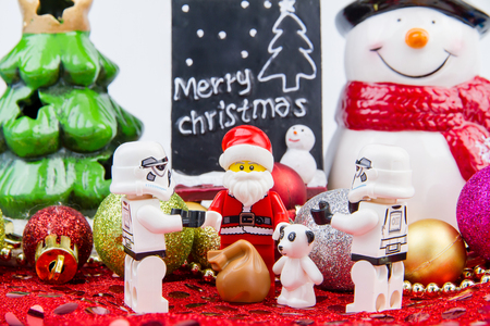 Nonthaburi, Thailand - November, 04, 2016 : Lego Santa Claus giving gifts to Lego star wars stormtrooper at Christmas.Theme Christmas day background.のeditorial素材