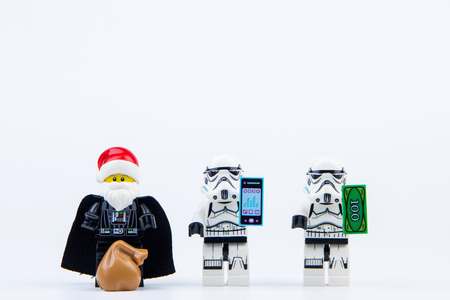 Nonthaburi, Thailand - November, 04, 2016 : Lego darth vader dressed as Santa Claus giving gifts to Lego star wars stormtrooper at Christmas.Theme Christmas day background.のeditorial素材