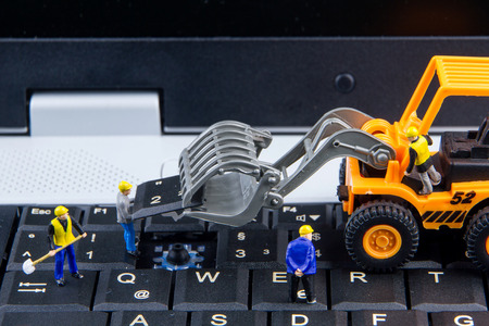 Tiny toys team of engineers repairing keyboard computer laptop.Computer equipment.Computer repair conceptの写真素材