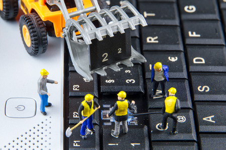 Tiny toys team of engineers repairing keyboard computer laptop.Computer equipment.Computer repair conceptの写真素材
