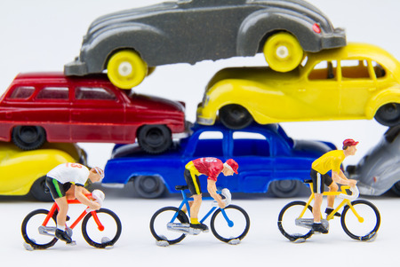 Miniature tiny toys cyclist ride bicycle in The abandoned car cemeteryの写真素材