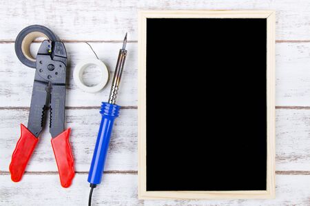 Blank blackboard and Set of repair hand tools.Template mock up for adding your design and leave space beside frame for adding more text.の写真素材