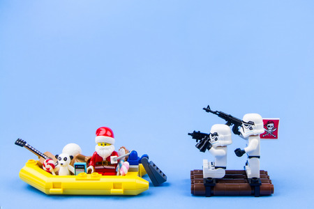 Nonthabure, Thailand - November, 21, 2016 : Lego star wars stormtrooper as pirate off the heist Lego Santa Claus transport yellow rubber speed boat to distribution gifts at Christmas.Theme Christmas day background.のeditorial素材