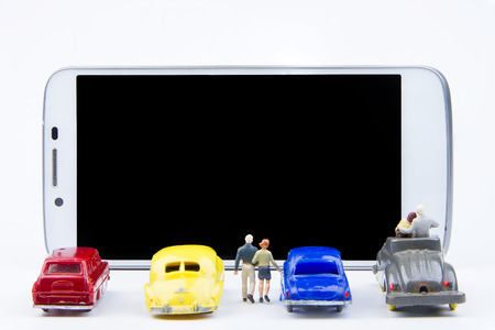 Miniature tiny toys use smartphone as a movie screen.Theme communication technology backgroundの写真素材