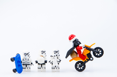 Nonthaburi, Thailand - November, 26, 2016 : Lego darth vader dressed as Santa Claus ride a motorcycle giving gifts to Lego star wars stormtrooper at Christmas.Theme Christmas day background.のeditorial素材