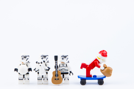 Nonthaburi, Thailand - November, 26, 2016 : Lego Santa Claus play skateboard giving gifts to Lego star wars stormtrooper at Christmas.Theme Christmas day background.のeditorial素材