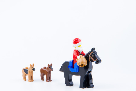 Nonthaburi, Thailand - November, 26, 2016 : Lego dog follow Lego Santa Claus ride a horse giving gifts at Christmas.Theme Christmas day background.のeditorial素材