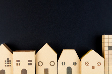 Home architectural model paper box cubes on black background with copy space.Real estate concept.の写真素材