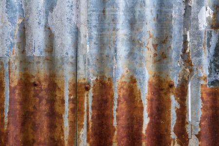 Old and rusty iron galvanise plate on house textures and color from past time.Was destroyed by the...