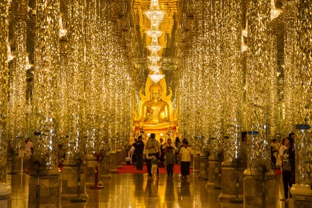 Uthai Thani, Thailand - December, 18, 2016 : Unidentified Tourist visit Golden Buddha statue in cathedral glass at the Wat Tha Sung Temple near Uthai Thani in Thailand.Uthai Thani is small town in central Thailandのeditorial素材