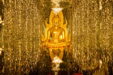 Uthai Thani, Thailand - December, 18, 2016 : Golden Buddha statue in cathedral glass at the Wat Tha Sung Temple near Uthai Thani in Thailand.Uthai Thani is small town in central Thailandのeditorial素材