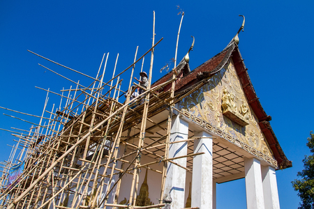 Kanchanaburi, Thailand - December, 25, 2016 : Unidentified Workers made scaffolding with bamboo construction renovation church at Wat Somdej temple Sangkhlaburi, Kanchanaburi.Thailand.のeditorial素材