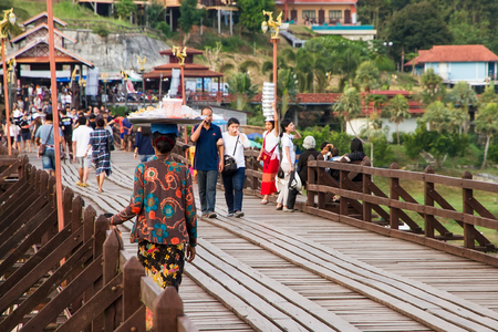Kanchanaburi, Thailand - December, 25, 2016 : Unidentified Tourist walk on the wooden bridge (Mon Bridge) over the river in sunset at Sangkhlaburi, Mon Bridge is the longest bridge in Thailandのeditorial素材