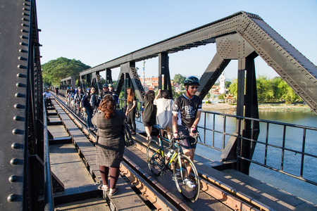 Kanchanaburi, Thailand - December, 25, 2016 : Unidentified Cyclists Tourist walk on The Railway Bridge on the River Kwai at Kanchanaburi,Thailand.This bridge is famous for its history in second world war.のeditorial素材