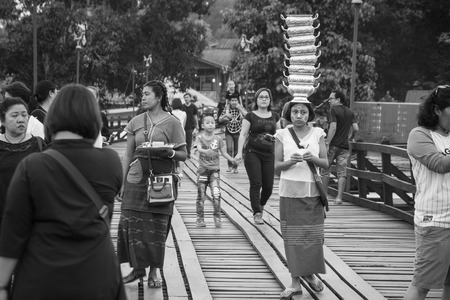 Kanchanaburi, Thailand - December, 25, 2016 : Unidentified Tourist walk on the wooden bridge (Mon Bridge) over the river in sunset at Sangkhlaburi, Mon Bridge is the longest bridge in Thailandのeditorial素材