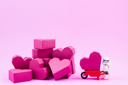 Nonthaburi, Thailand - January, 09, 2017 : Lego star wars stormtrooper carry a paper box red heart shape on pink background with copy space for your text.Concept Valentine's Dayのeditorial素材