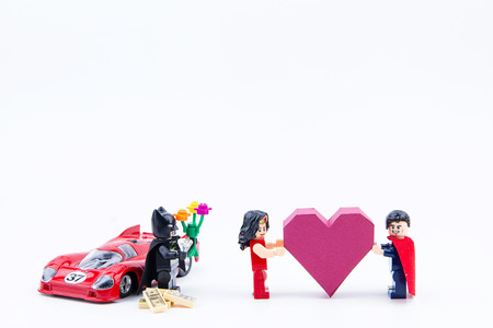 Nonthaburi, Thailand - January, 09, 2017 : Lego super man showing love give a paper box red heart...