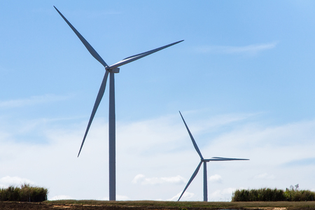 Power of wind turbine generating electricity clean energy with cloud background on the blue sky.Global ecology.Clean energy concept save the worldの写真素材