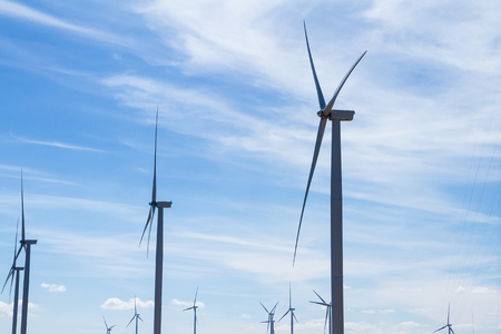 Power of wind turbine generating electricity clean energy with cloud background on the blue sky.Global ecology.Clean energy concept save the worldの写真素材