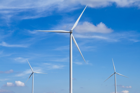 Power of wind turbine generating electricity clean energy with cloud background on the blue sky.Global ecology.Clean energy concept save the worldの写真素材