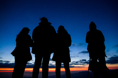 Phetchabun, Thailand - January, 21, 2017 : Silhouettes of Tourists come to see and photograph the sunrise in the morning at Phu Lom Lo, Phu Hin Rong Kla National Park, Phetchabun, Thailand.のeditorial素材